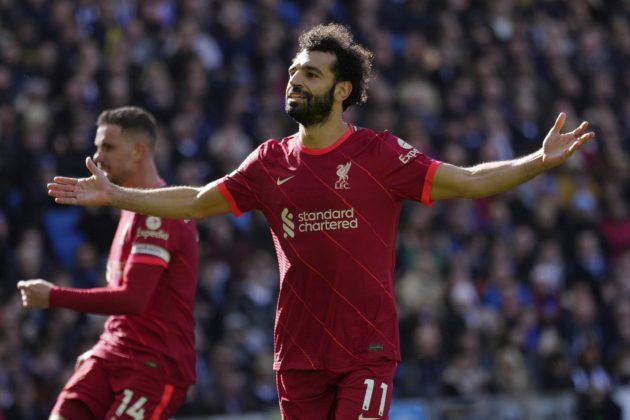 Liverpool's Mohamed Salah celebrates after scoring his side's second goal on a penalty kick during the English Premier League soccer match between Brighton and Hove Albion