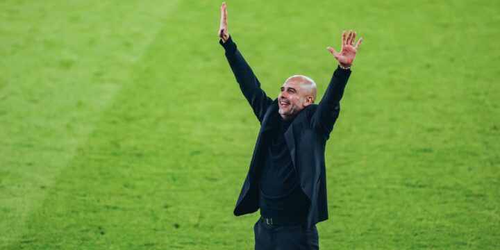 Pep Guardiola celebrating Manchester City's victory against Real Madrid at the Etihad Stadium.