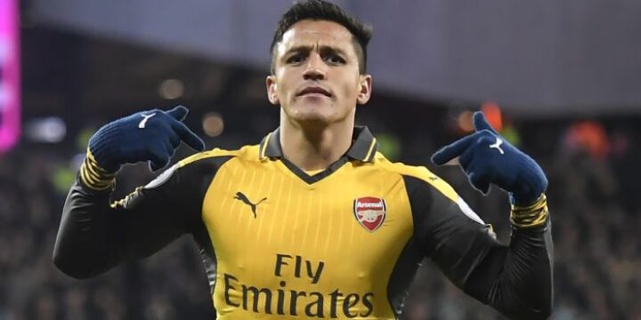 Alexis Sanchez celebrating his goal for Arsenal in the yellow and dark blue jersey