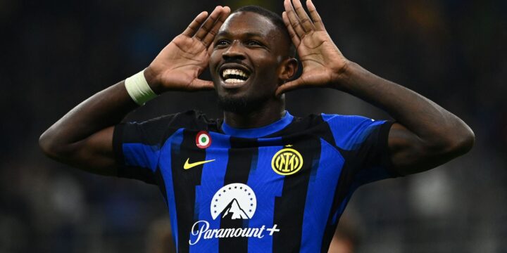 Marcus Thuram celebrating his goal  for Inter Milan in the club's home jersey with his hands on his ears