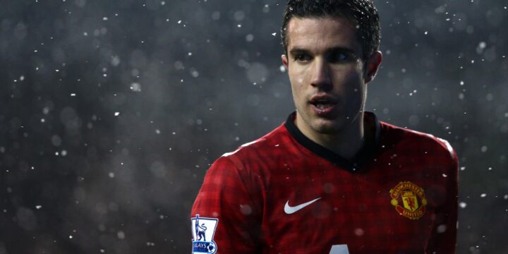 Robin Van Persie in Manchester United's red, white and black collared jersey after his move from Arsenal