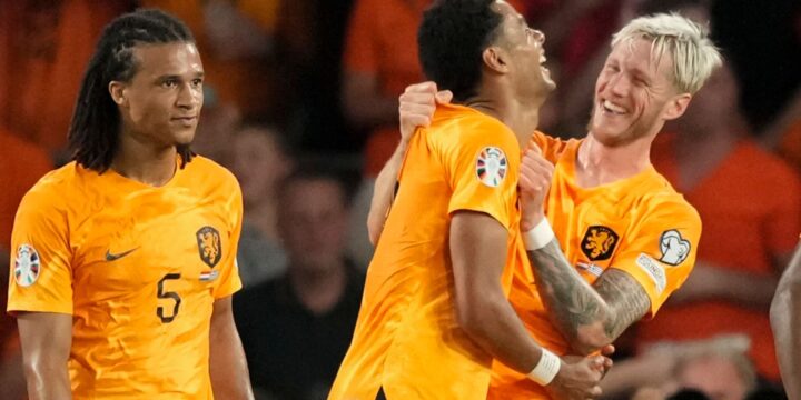 Nathan Ake, Cody Gakpo and anothe rplayer of The Netherlands celebrating a goal for the national side in their orange jersey
