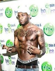 Burna boy shirtless at a Glo Event