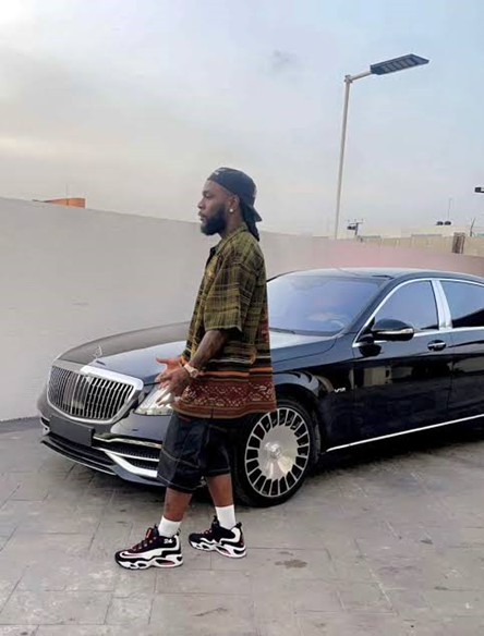 Photo of Burna with one of his cars