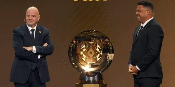 Gianni Infantino and Ronaldo Delima posing with the FIFA Club World Cup